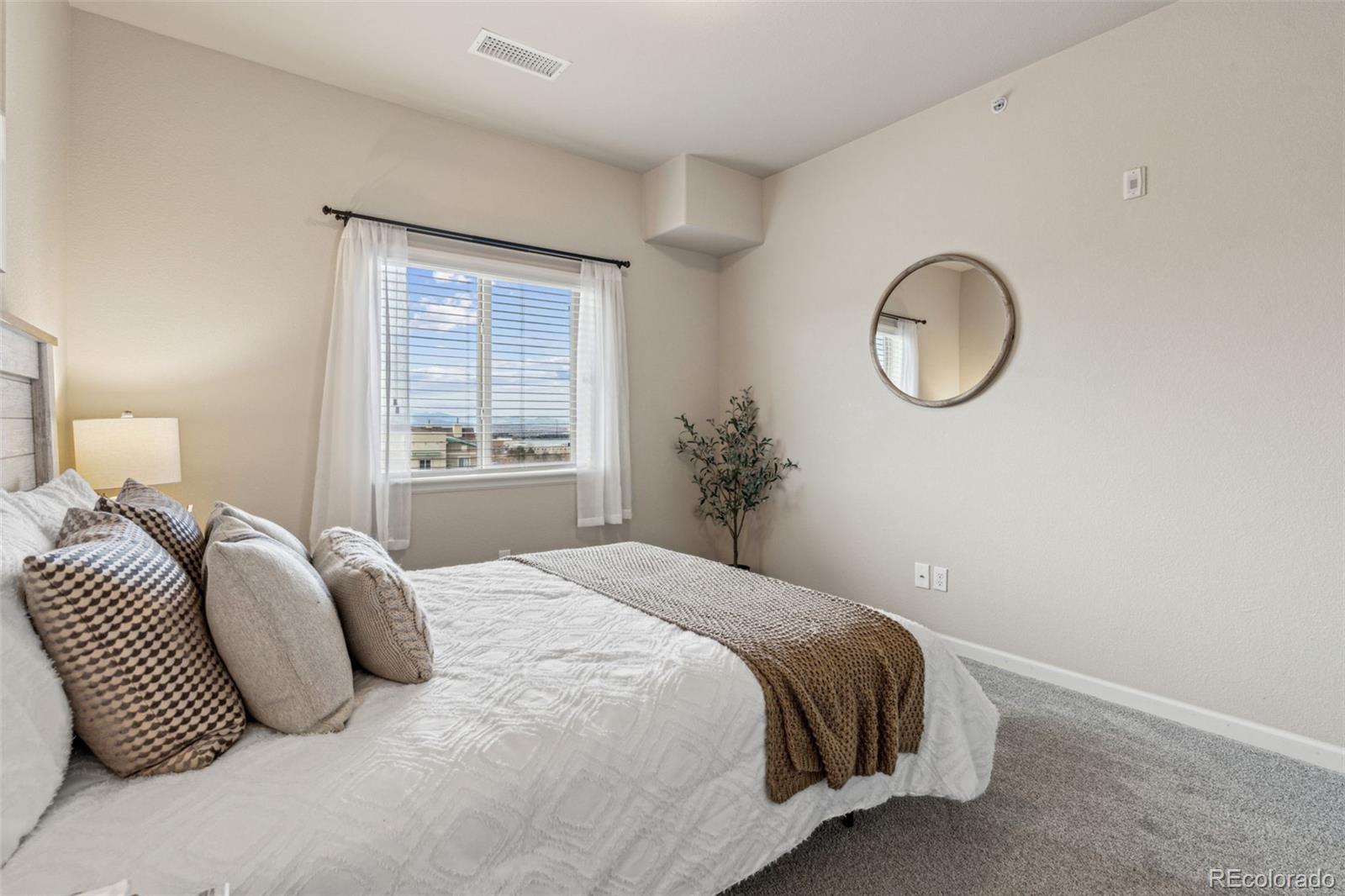1062 Rockhurst Drive, Unit 401 Highlands Ranch, CO 80129 - Photo 26 of 41 a bedroom with a bed and a window