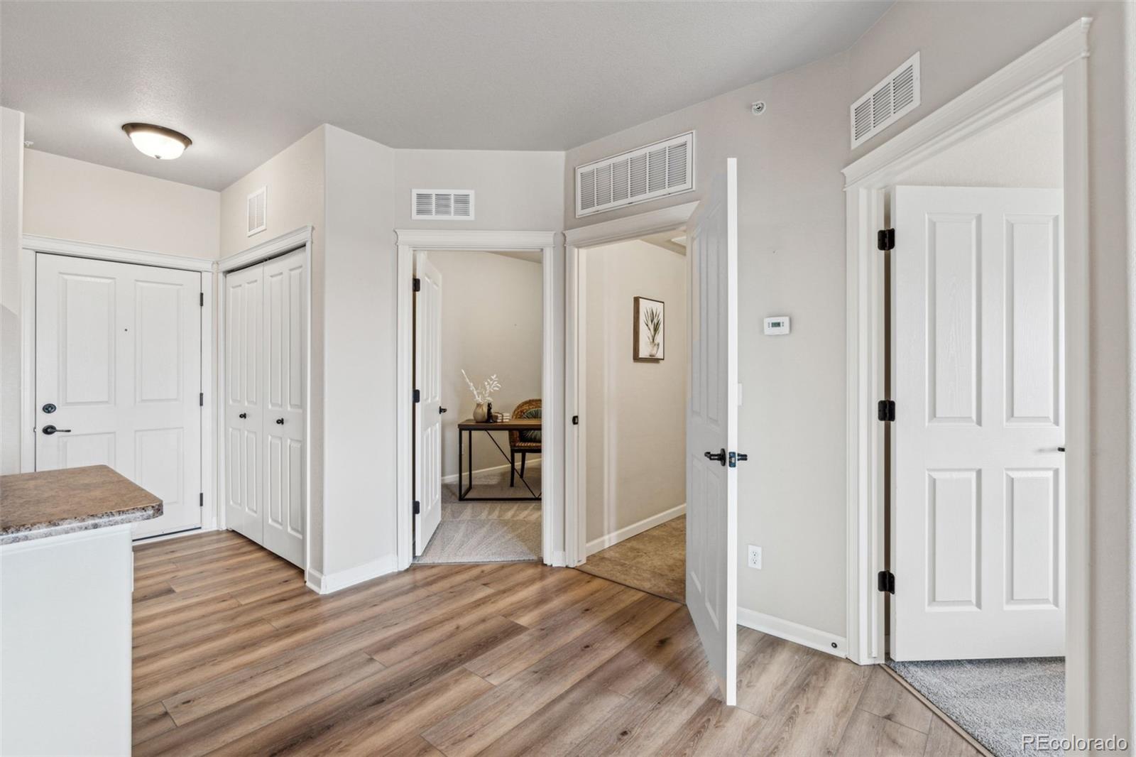 1062 Rockhurst Drive, Unit 401 Highlands Ranch, CO 80129 - Photo 28 of 41 a view of a hallway with wooden floor and closet area