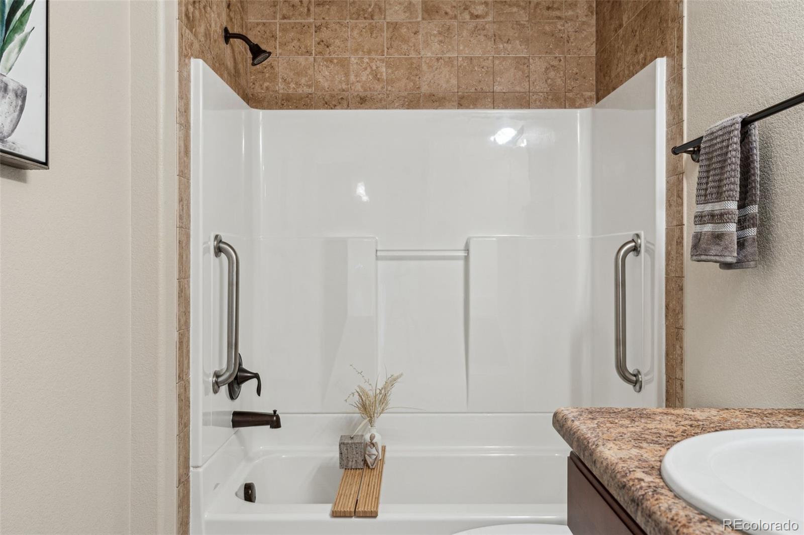 1062 Rockhurst Drive, Unit 401 Highlands Ranch, CO 80129 - Photo 33 of 41 a bathroom with a granite countertop sink and a mirror