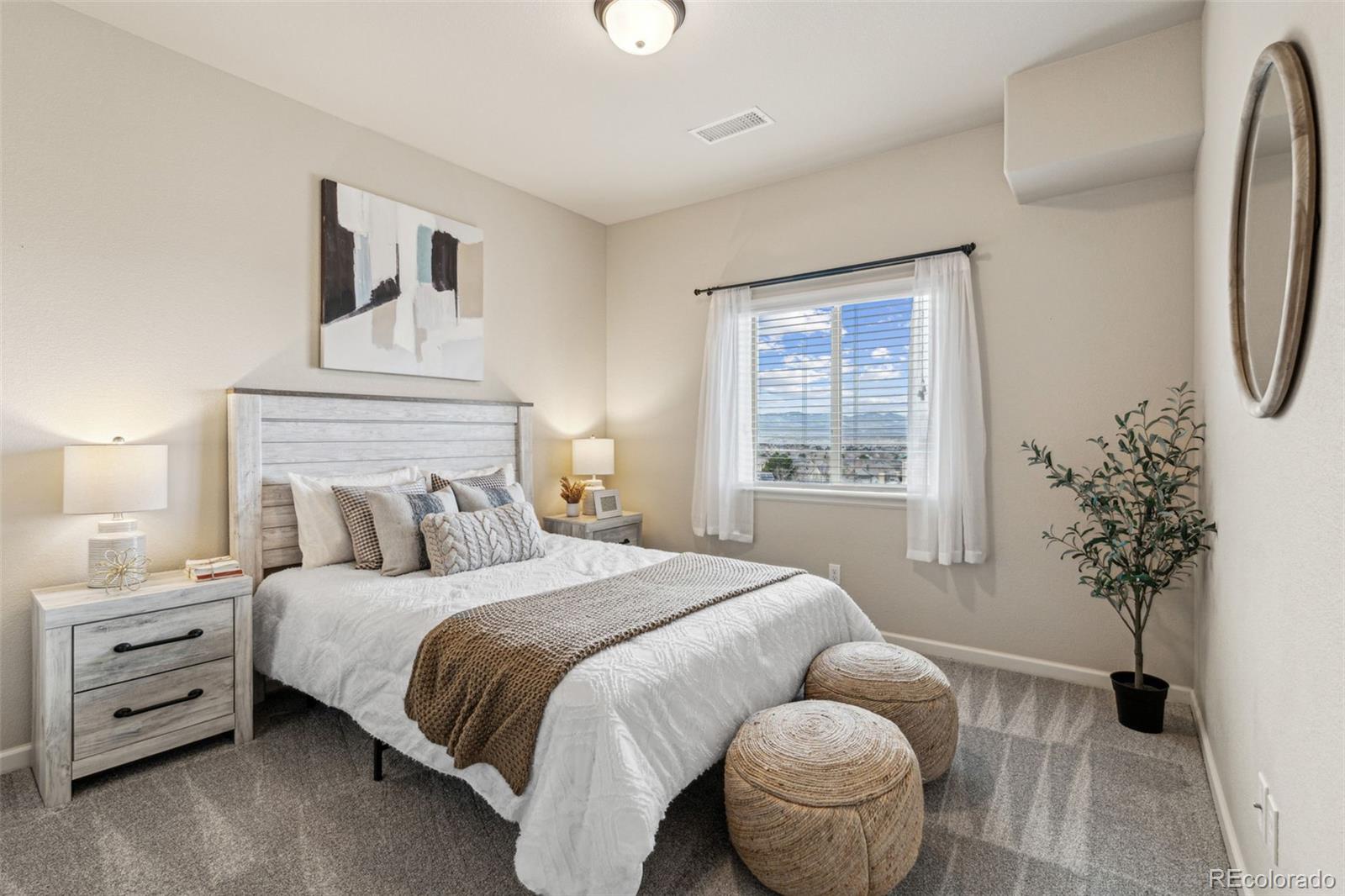 1062 Rockhurst Drive, Unit 401 Highlands Ranch, CO 80129 - Photo 4 of 41 a bedroom with a bed and a potted plant