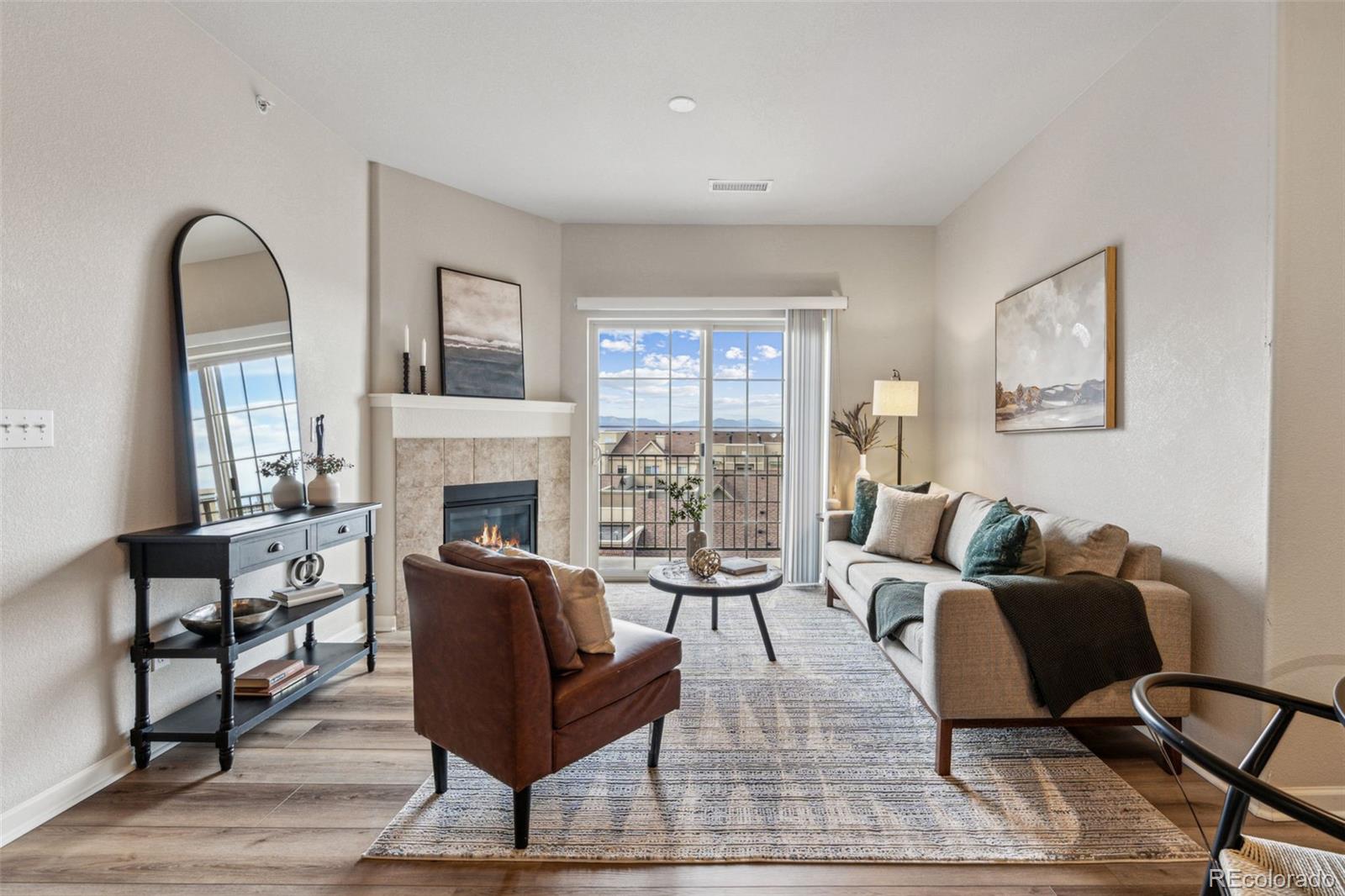 1062 Rockhurst Drive, Unit 401 Highlands Ranch, CO 80129 - Photo 6 of 41 a living room with furniture and a fireplace