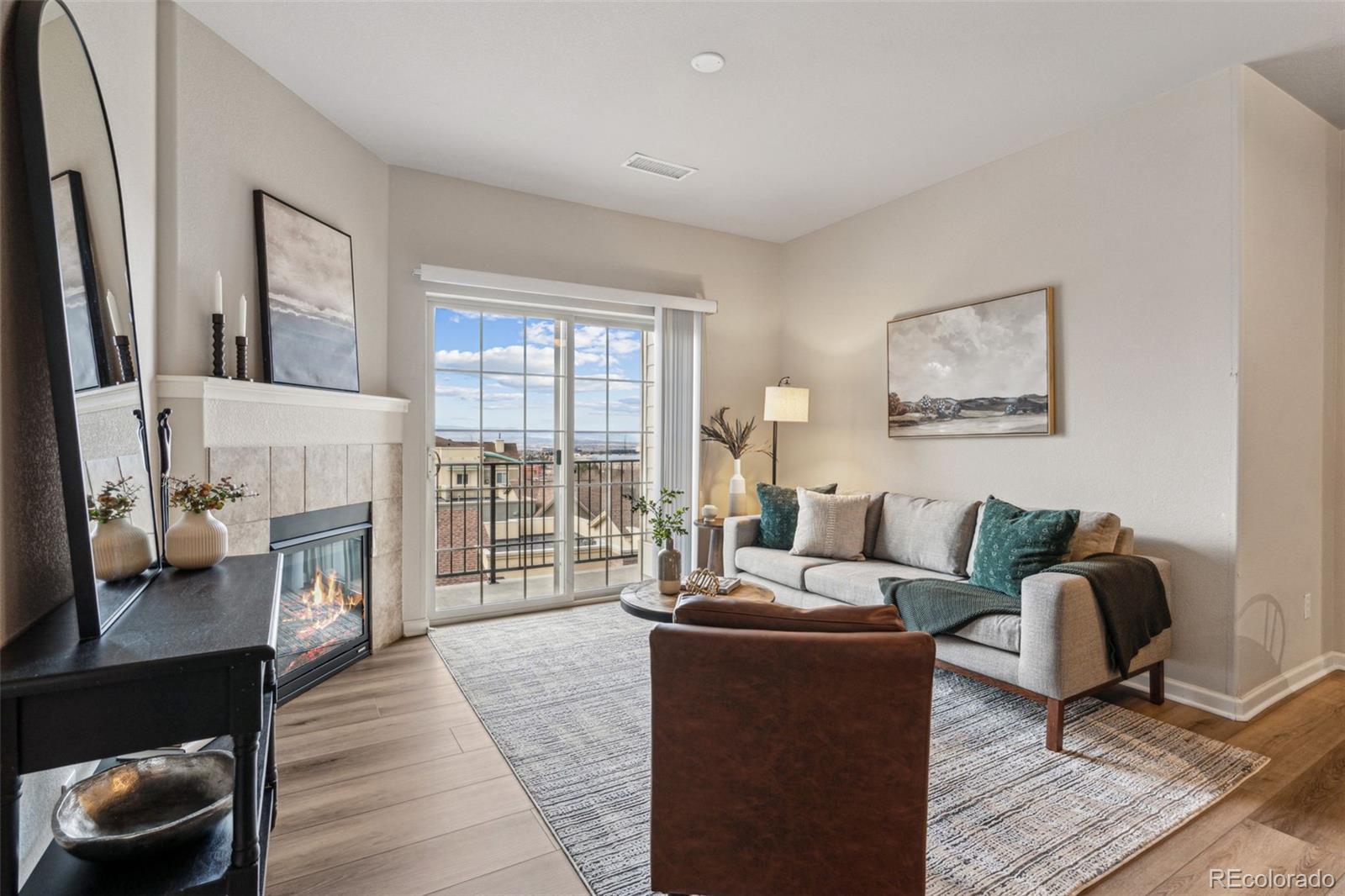1062 Rockhurst Drive, Unit 401 Highlands Ranch, CO 80129 - Photo 7 of 41 a living room with furniture and a fireplace