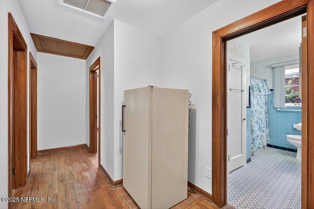 1111 Inwood Terrace Jacksonville, FL 32207 - Photo 24 of 46 a view of a hallway with wooden floor and a livingroom
