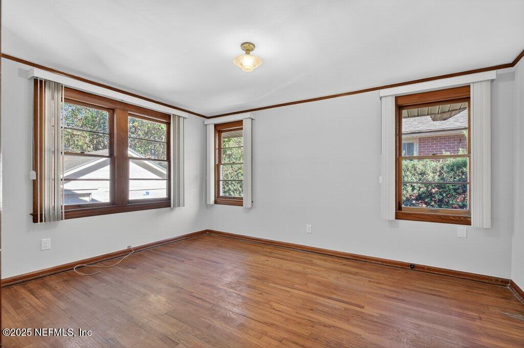 1111 Inwood Terrace Jacksonville, FL 32207 - Photo 31 of 46 a view of an empty room with wooden floor and a window