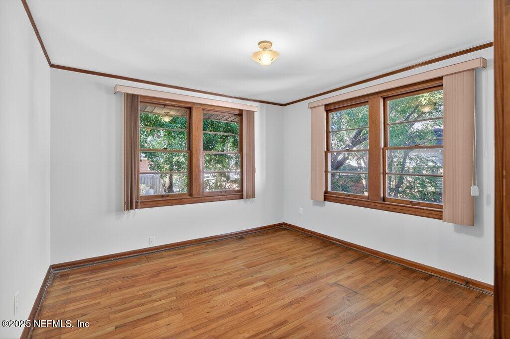 1111 Inwood Terrace Jacksonville, FL 32207 - Photo 35 of 46 a view of an empty room with wooden floor and a window
