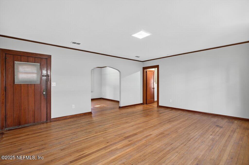 1111 Inwood Terrace Jacksonville, FL 32207 - Photo 8 of 46 an empty room with wooden floor and windows