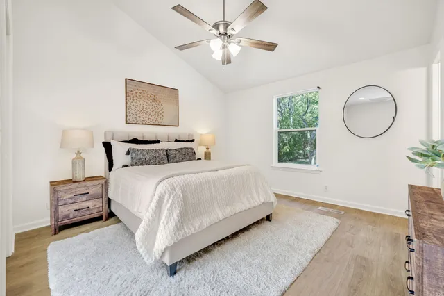 a bedroom with a bed mirror and a window
