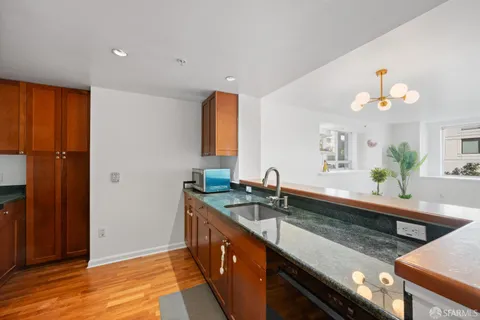 a large kitchen with a sink and a large window