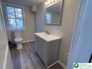 1924 Rt 212, Unit A Quakertown, PA 18951 - Photo 13 of 23 a bathroom with a sink toilet a mirror and vanity