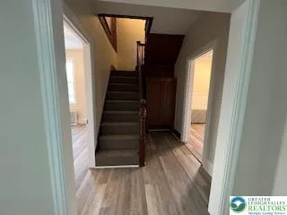 a view of entryway with wooden floor and stairs