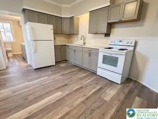a kitchen with a white cabinets and white appliances