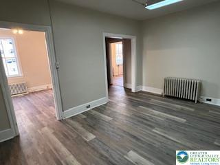 1924 Rt 212, Unit A Quakertown, PA 18951 - Photo 10 of 23 an empty room with wooden floor and a window