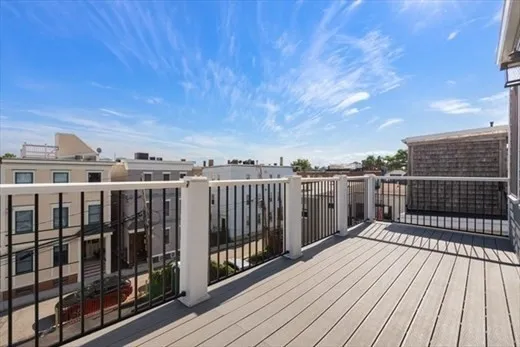a view of a balcony with wooden floor