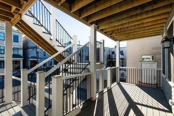 a view of staircase with wooden floor and white walls