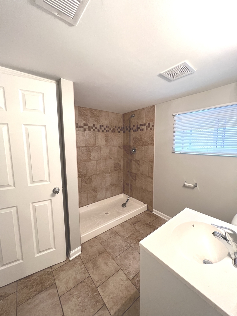 4409 Home Avenue Stickney, IL 60402 - Photo 19 of 21 a bathroom with a bathtub and a shower