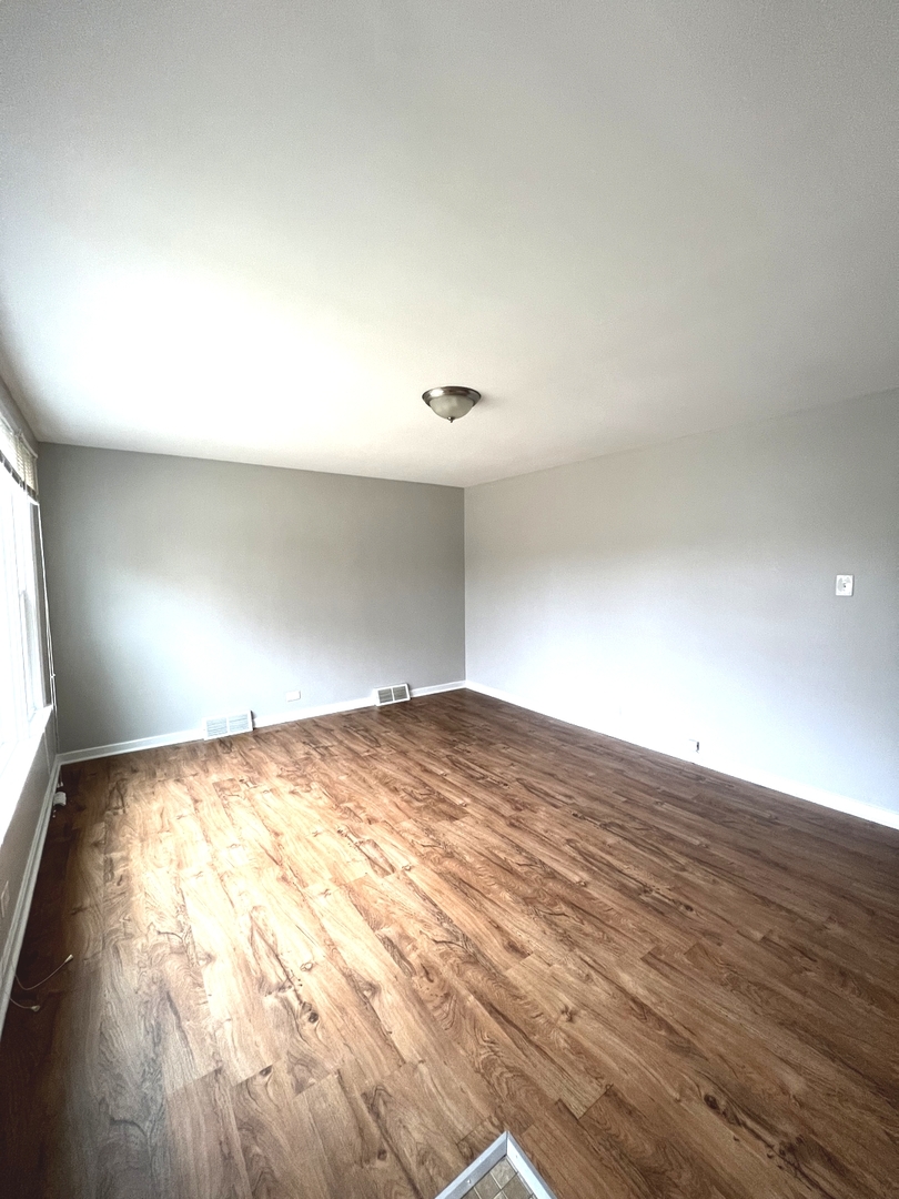 4409 Home Avenue Stickney, IL 60402 - Photo 4 of 21 a view of empty room with wooden floor and fan