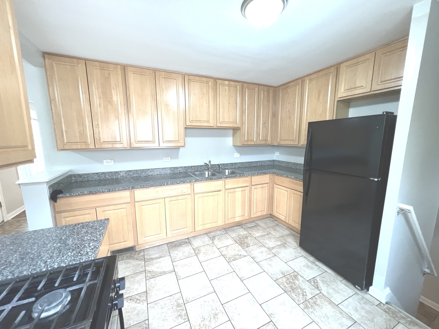 4409 Home Avenue Stickney, IL 60402 - Photo 7 of 21 a kitchen with granite countertop a refrigerator a sink a stove a microwave and cabinets