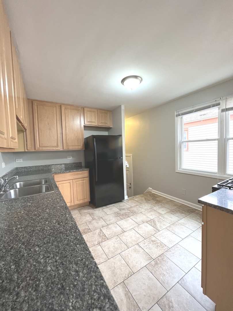 4409 Home Avenue Stickney, IL 60402 - Photo 10 of 21 a view of kitchen with granite countertop cabinets and refrigerator