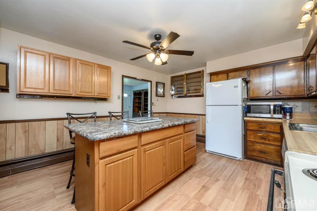 267 County Road 539 Cream Ridge, NJ 08514 - Photo 13 of 40 a kitchen with granite countertop kitchen island stainless steel appliances a refrigerator sink and microwave