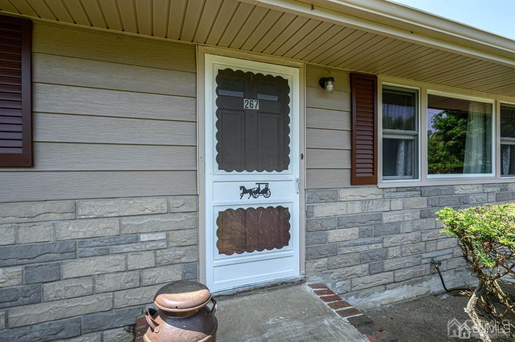 267 County Road 539 Cream Ridge, NJ 08514 - Photo 2 of 40 a front view of a house with a chairs and potted plant