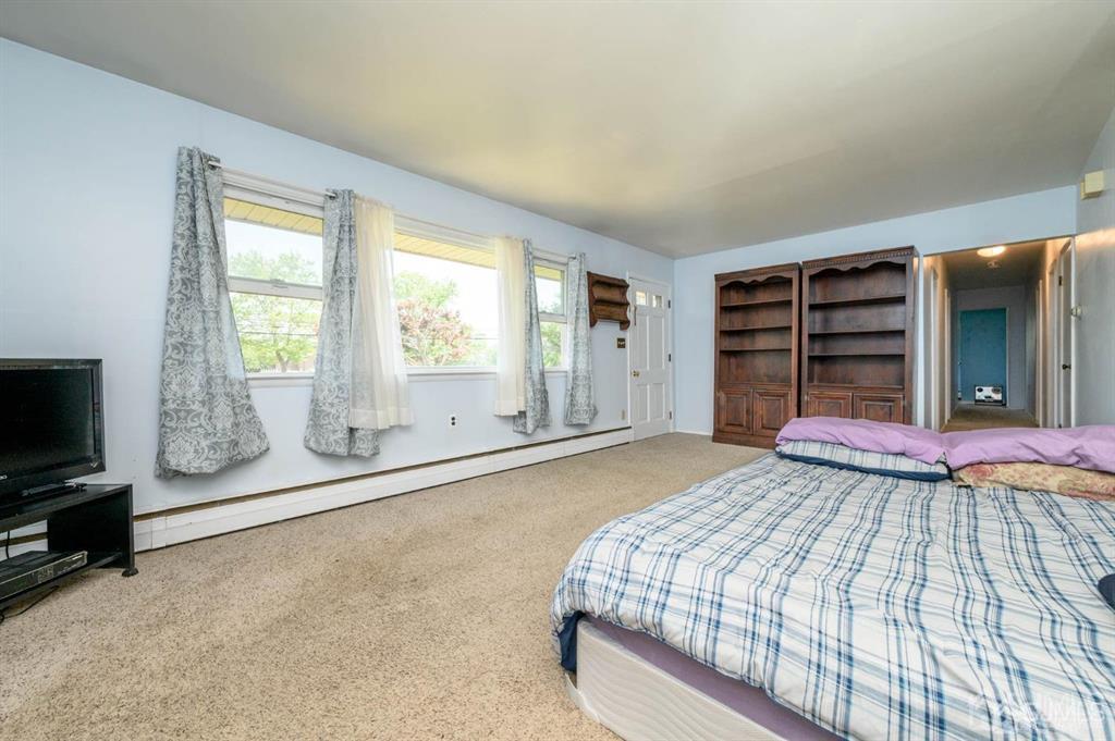 267 County Road 539 Cream Ridge, NJ 08514 - Photo 5 of 40 a bedroom with a bed and a flat screen tv