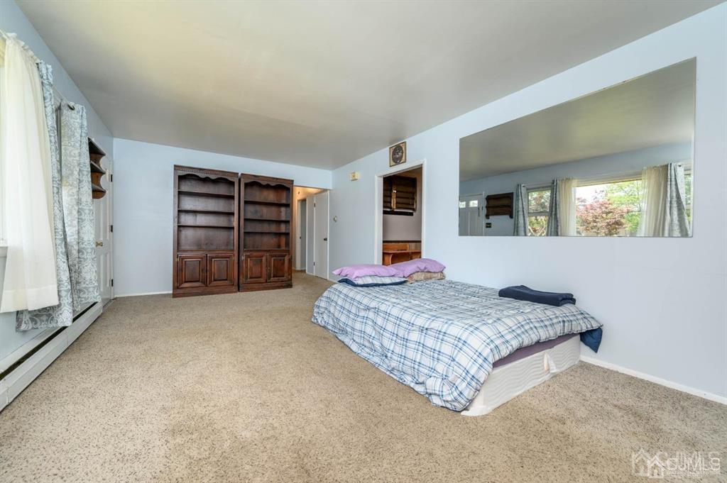 267 County Road 539 Cream Ridge, NJ 08514 - Photo 6 of 40 a spacious bedroom with a bed and a large mirror in it