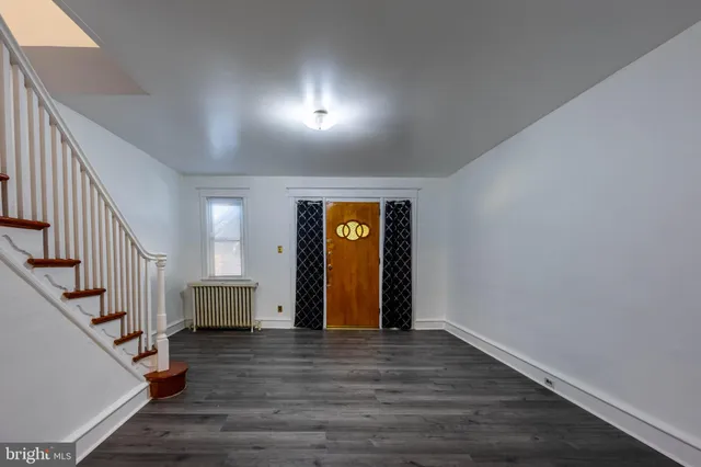 a view of an entryway with wooden floor