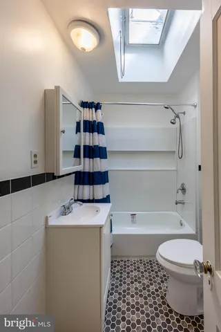 a bathroom with a bathtub a toilet and a shower