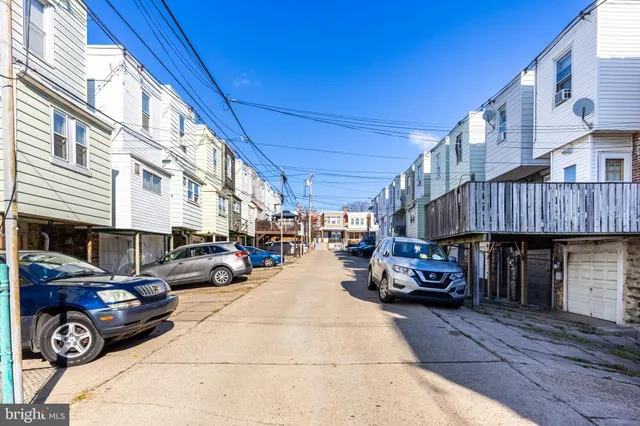 a view of a cars park in front of a building