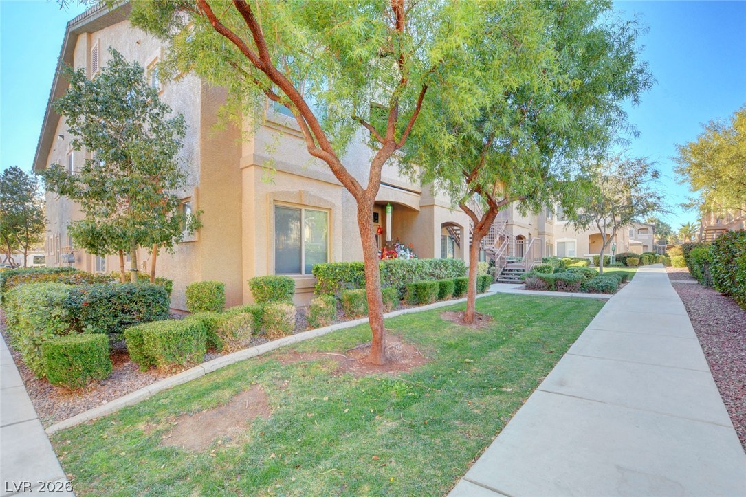 8985 South Durango Drive, Unit 2187 Las Vegas, NV 89113 - Photo 67 of 73 Manicured landscaping and concrete walkways lead to welcoming entryways of this residential complex.