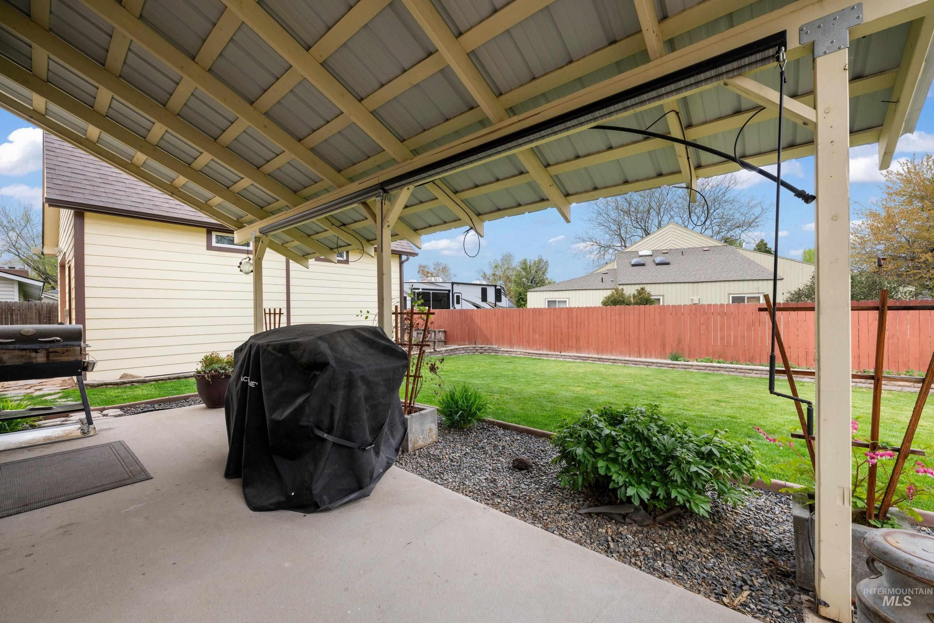 1921 Incline Way Meridian, ID 83646 - Photo 45 of 50 Patio with a metal roof covering, exposed wood beams, and a concrete slab