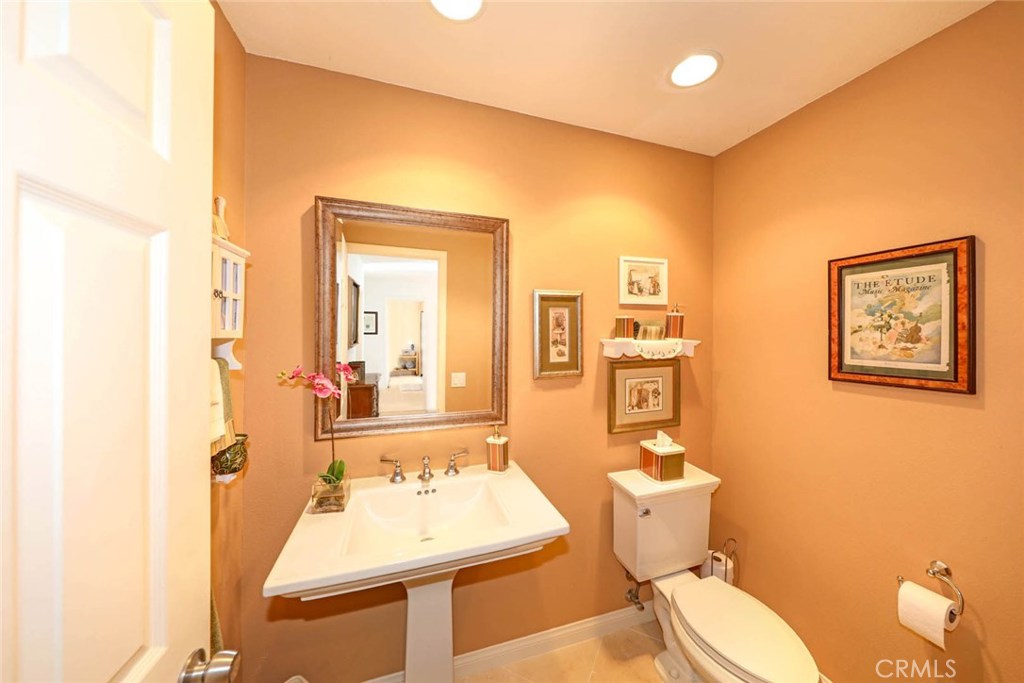 4 Lucerne, Unit 22 Newport Beach, CA 92660 - Photo 16 of 20 a bathroom with a sink mirror vanity and toilet