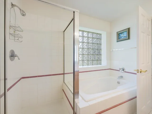 a white bath tub sitting next to a window