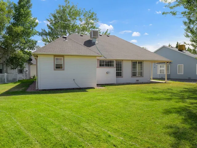 a view of a house with a backyard