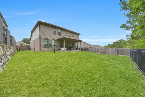 a view of a house with a yard and sitting area