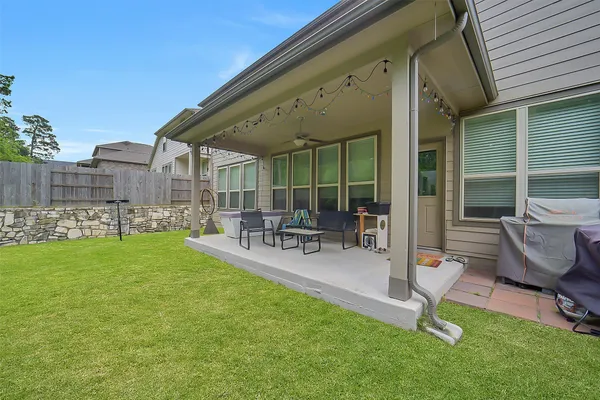 a building outdoor space with patio furniture and garden