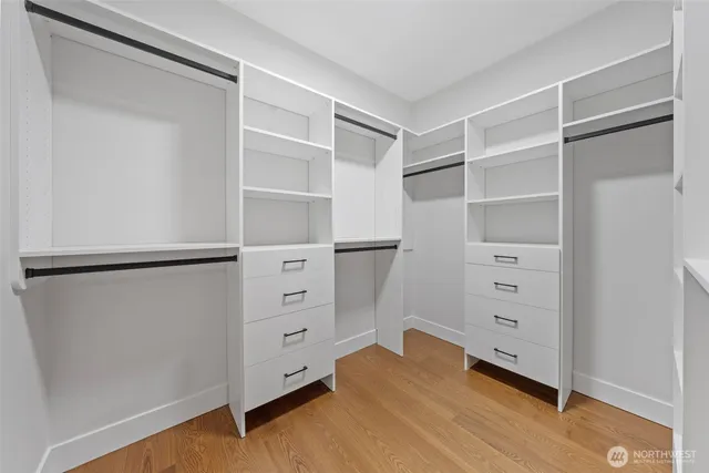 a view of walk in closet with empty racks