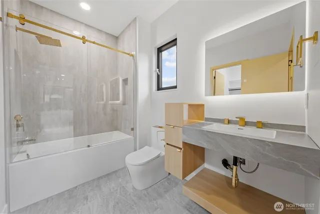 a bathroom with a sink a toilet and a bathtub