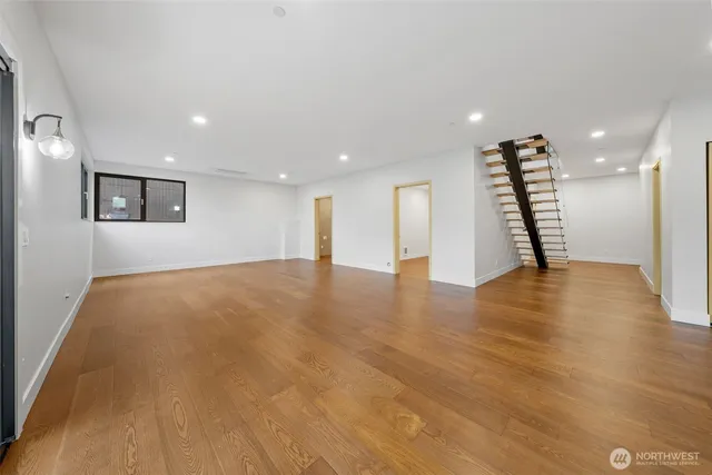 a view of empty room with wooden floor