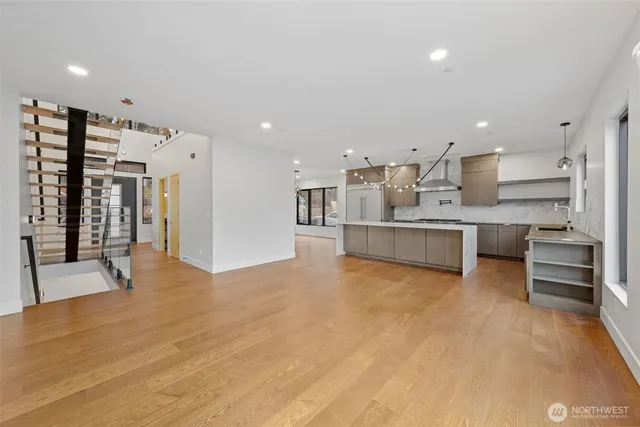 a large kitchen with stainless steel appliances kitchen island a large counter top and a stove top oven