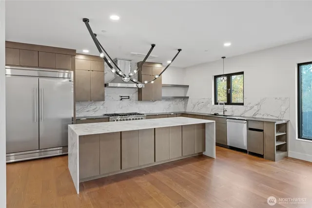 a large kitchen with a stove and a refrigerator