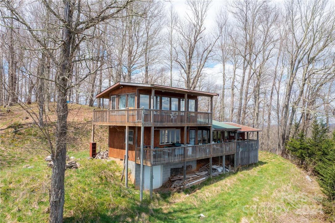 1375 Swing Road Burnsville, NC 28714 - Photo 26 of 48 a backyard of a house with swimming pool table and chairs