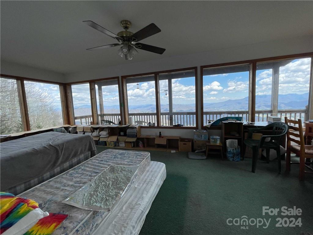 1375 Swing Road Burnsville, NC 28714 - Photo 33 of 48 a living room with furniture and a floor to ceiling window