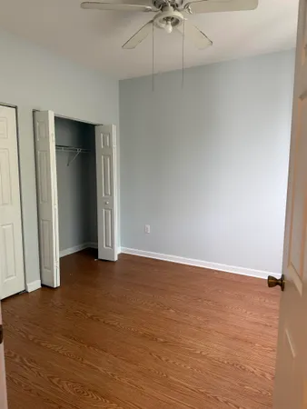 a view of an empty room with a ceiling fan