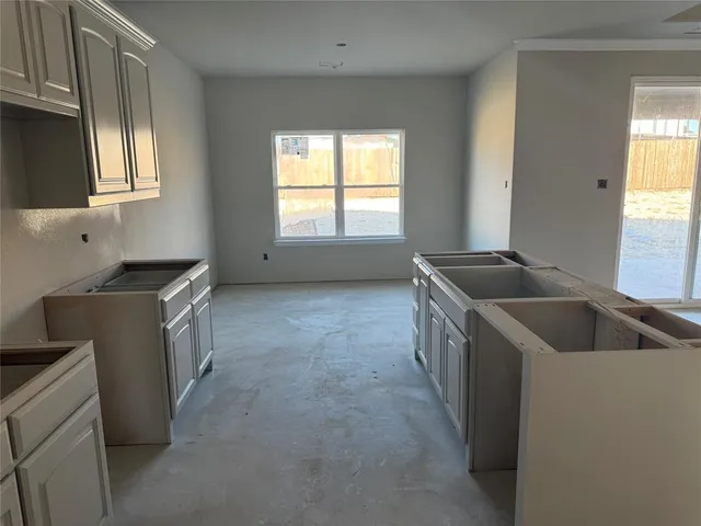 a kitchen that has a sink a stove and window