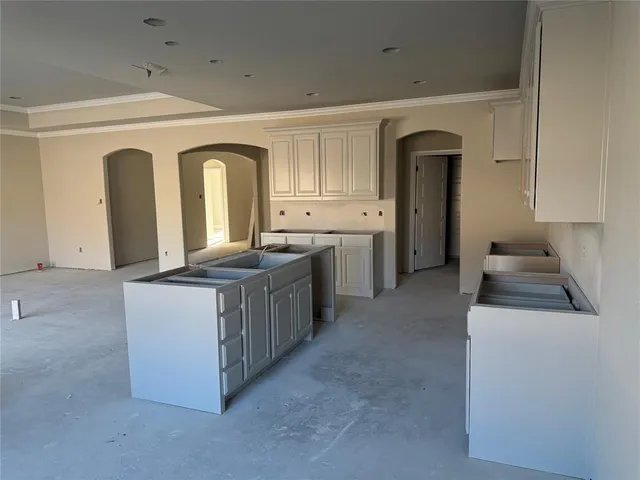 a kitchen with sink and cabinets