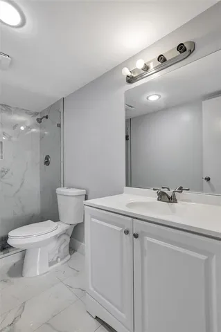 a bathroom with a sink toilet and shower