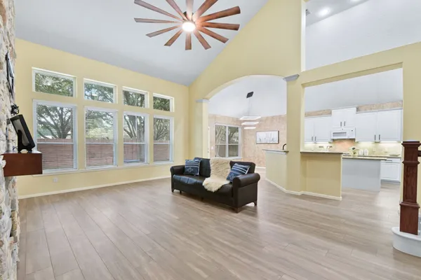 a living room with furniture and large windows