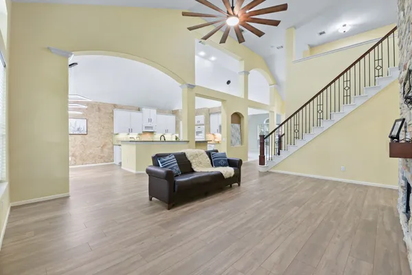 a living room with furniture and a chandelier