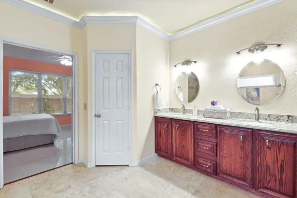 a spacious bathroom with a double vanity sink and a mirror